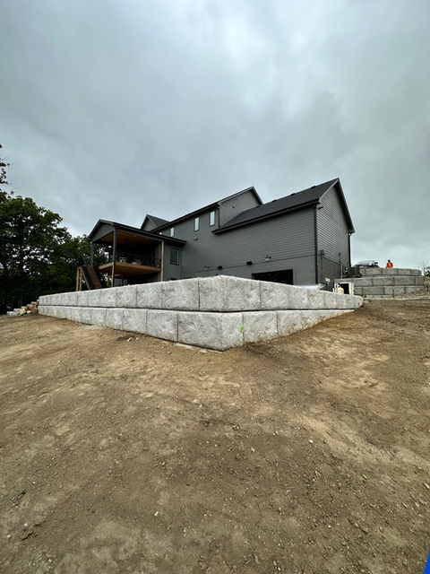 corner of large block retaining wall on graded dirt