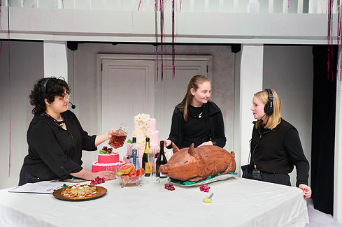 3 stage managers talking around a onstage table