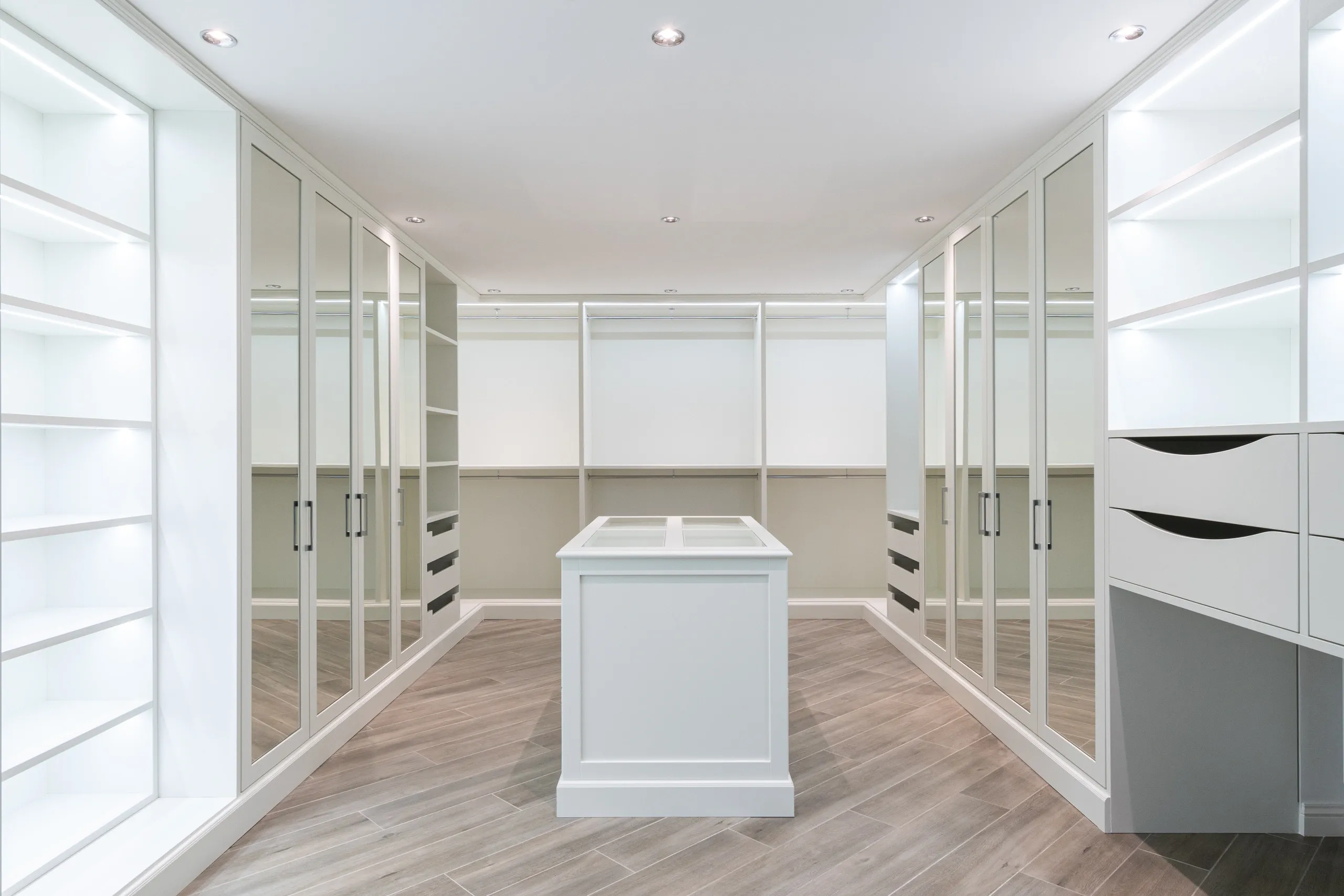 beautiful walk in closet with mirrored doors