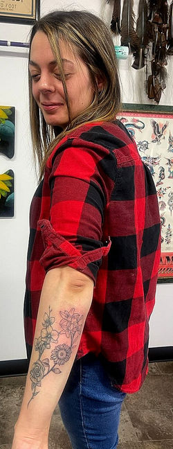 Rikki adding to her flowers tattoo by The Red Parlour Tattoo