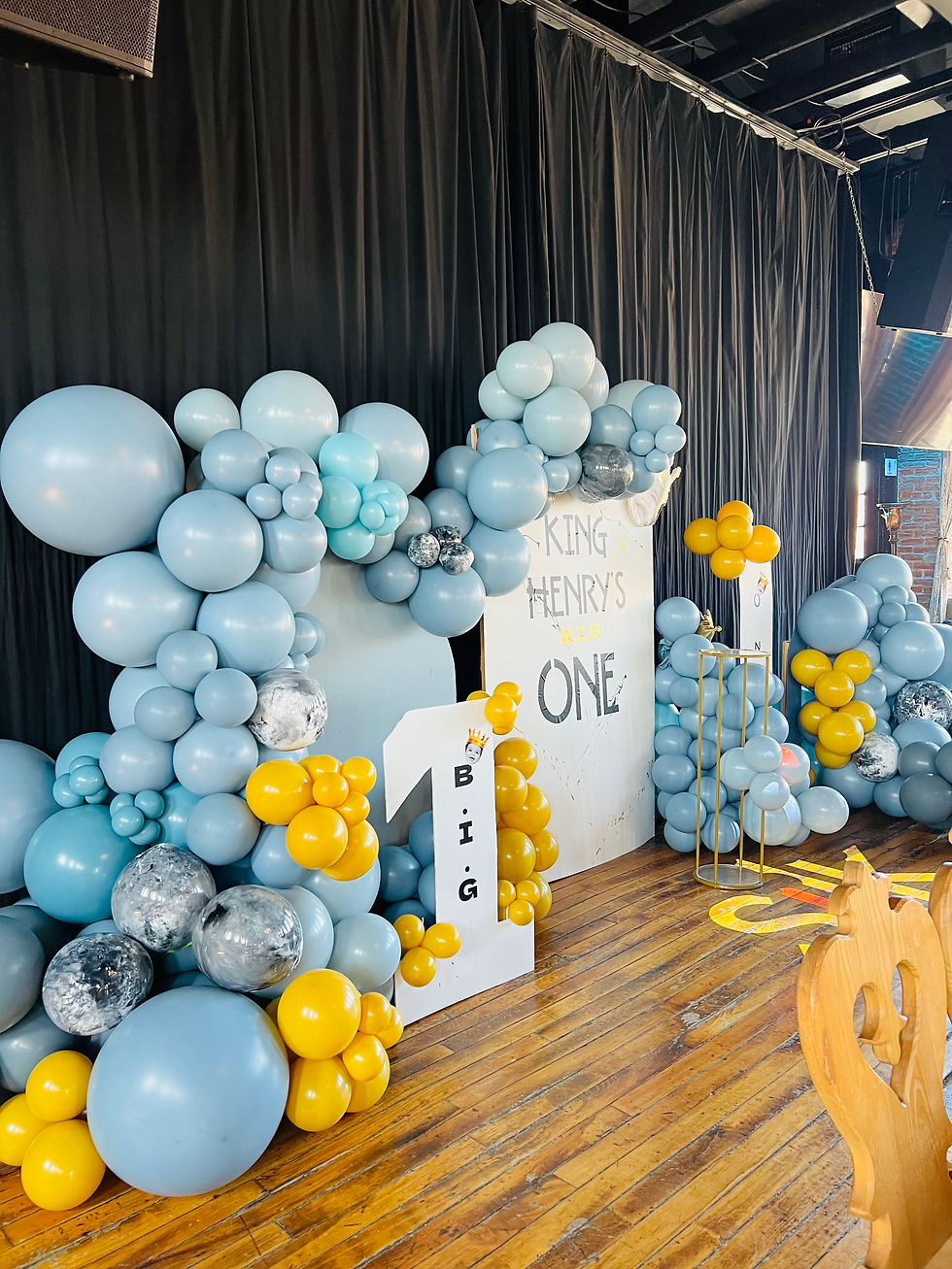 A luxury event vignette styled by Madeline’s Room LLC at The Silk Factory in Newburgh, NY. The "King of New York" theme features custom-layered organic balloon arches in denim blue, marble, and gold. This professional installation demonstrates high-end event architecture and bespoke balloon design for milestone celebrations in the Hudson Valley.