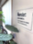 photo of a momster sign on a white background with some plants