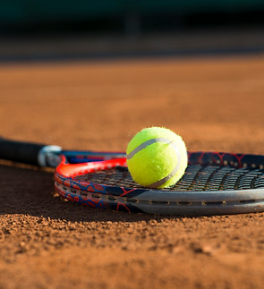 close-up-tennis-ball-racket-placed-floor.jpg