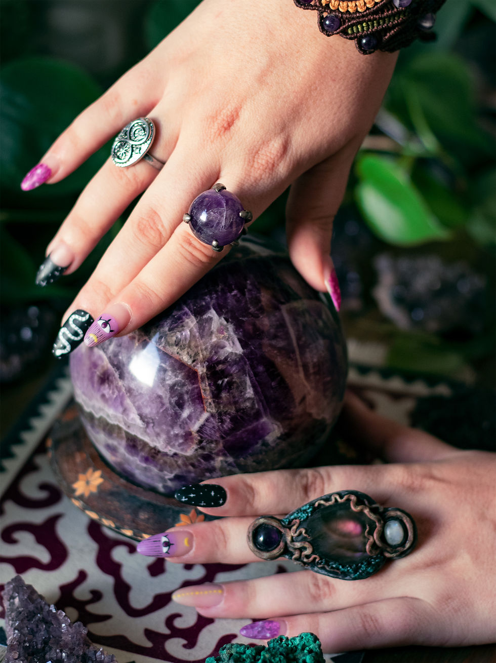 Hands holding amethyst crystal ball with rings, How to choose the right Crystals or Gemstones for you?