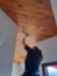 Member of the team fitting a smoke alarm