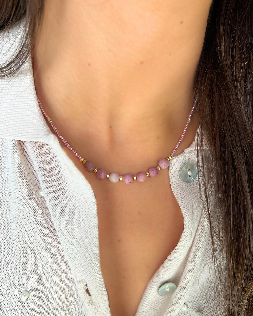 Miniatura: Collar artesanal de madera fosilizada con cuentas Miyuki y acero hipoalergénico, visto en plano medio sobre el cuello de una