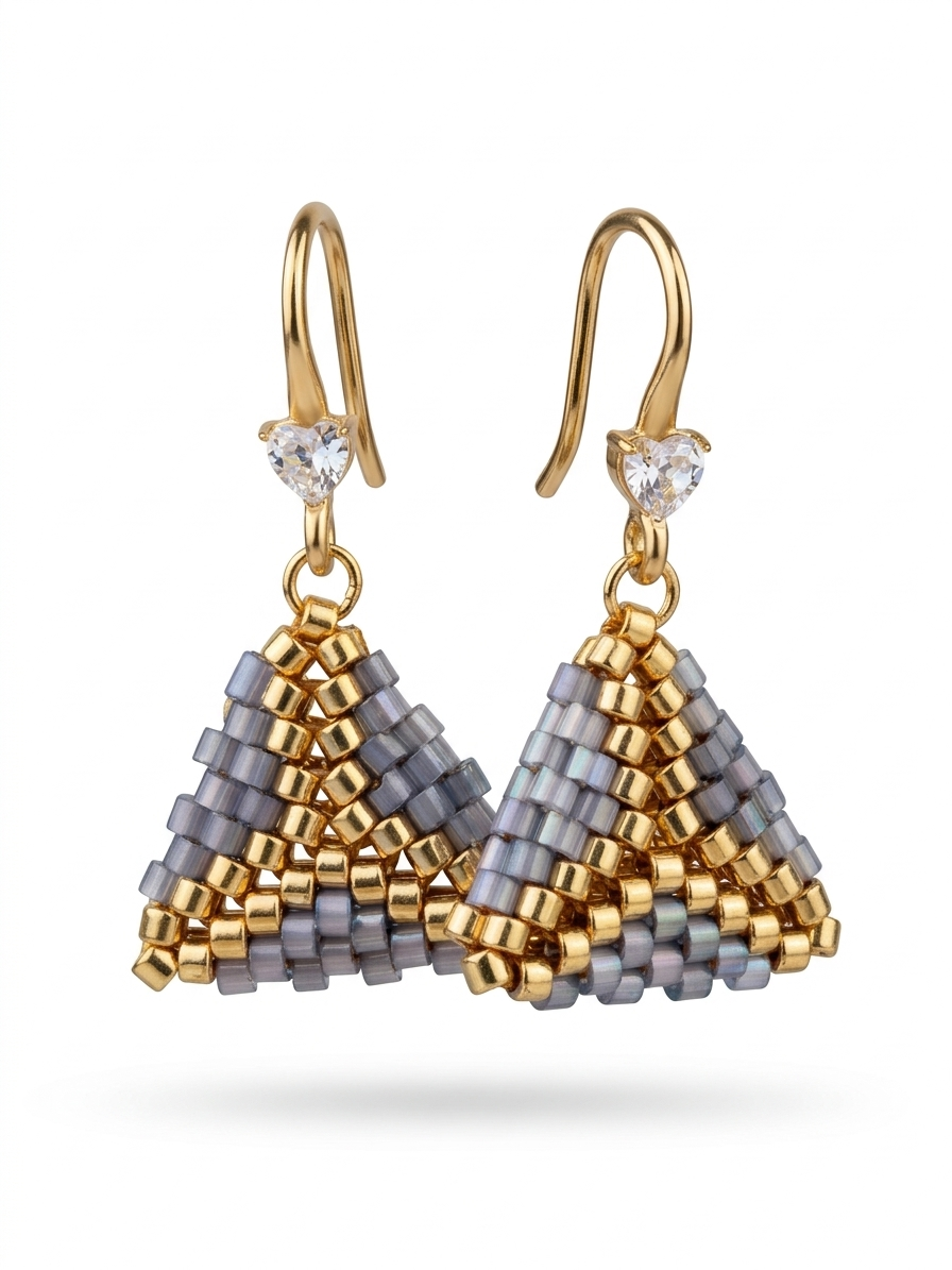 Primer plano de pendientes Livia triangulares con cuentas Miyuki grises iridiscentes y acero dorado.