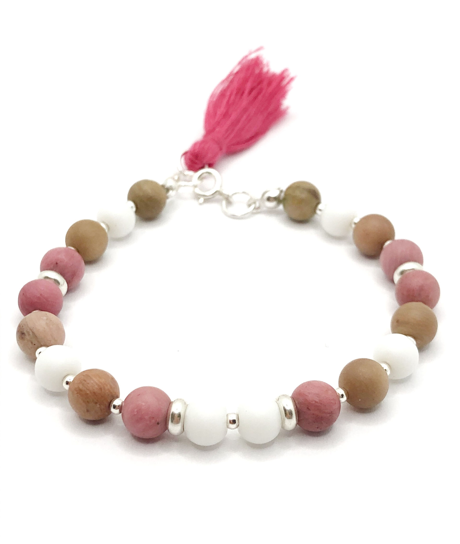 Pulsera Nude hecha a mano con ágatas blancas, cuentas de madera natural y detalles en plata de ley. Su diseño minimalista y elegante la convierte en un accesorio versátil, ideal para un look boho-chic o casual. Perfecta para quienes buscan joyería artesanal con materiales naturales y un toque sofisticado.