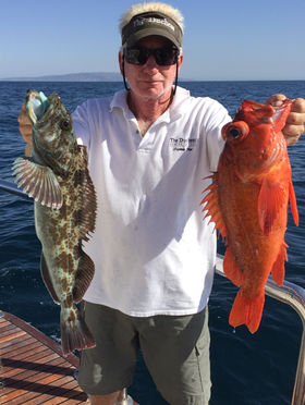 Captain Skip with a couple of many fish caught aboard The Duchess