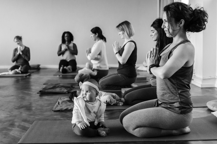 community of new mothers and their babies doing yoga
