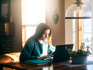 High school senior preparing for college applications with laptop, planner, and notebook during the summer before senior year.