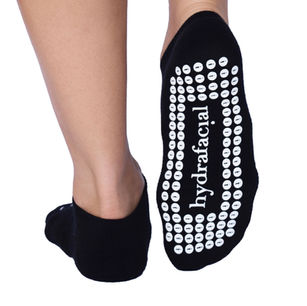 Custom black grip socks featuring branding for beauty or wellness marketing campaigns