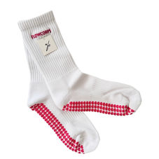 White socks with custom embroidered logo, showcasing trending embroidery for Pilates, barre, and lagree fitness studios.