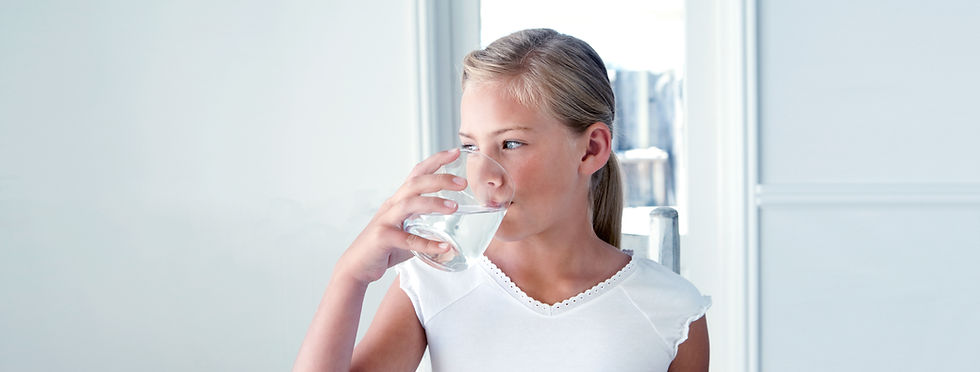 Girl drinking a glass of filter water