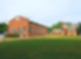 two old brick mill buildings surrounded by grass
