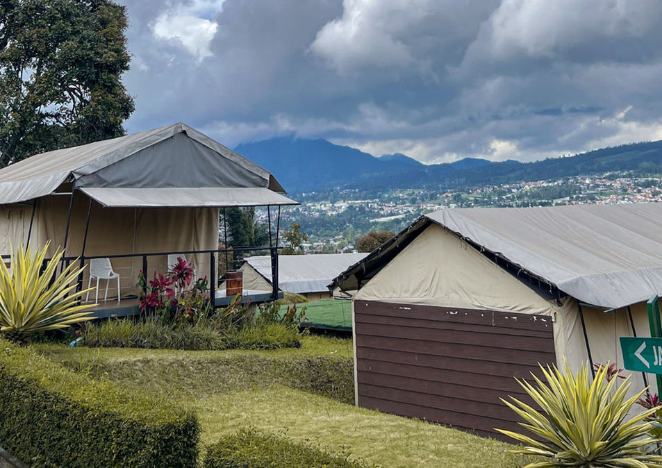 Garden walkway between canvas glamping tents at Trizara Resorts.