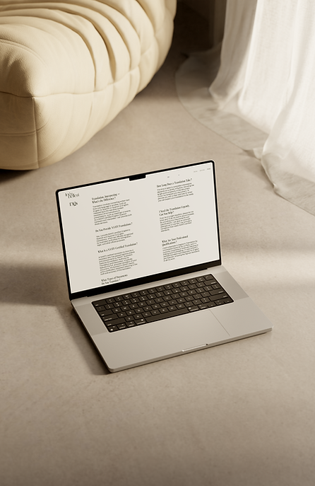 A sleek laptop sits on a cream ottoman, displaying the website of Inés Bellesi, a NAATI-certified English-Spanish translator