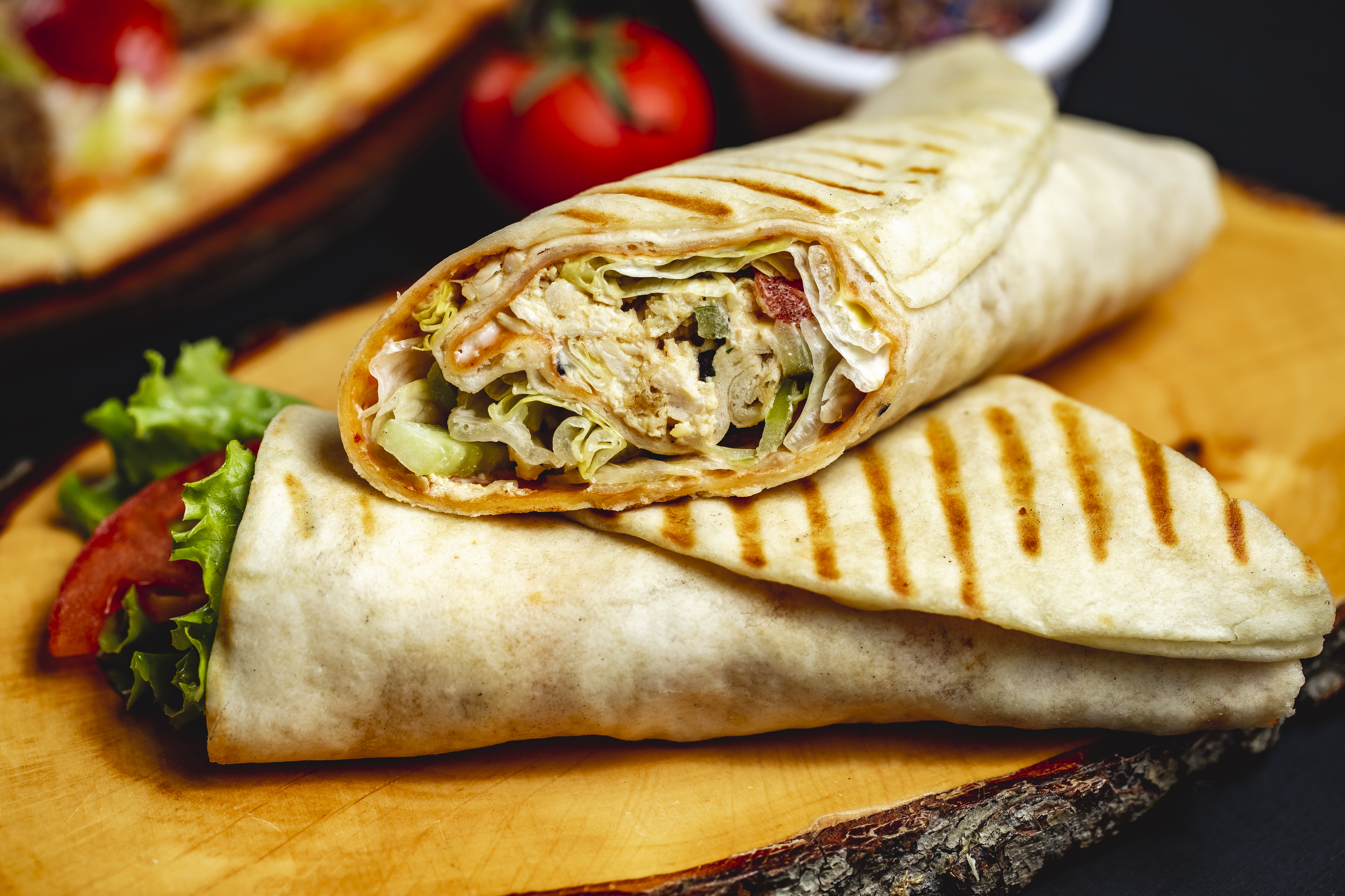 side-view-chicken-roll-grilled-chicken-lettuce-cucumber-tomato-mayo-pita.jpg