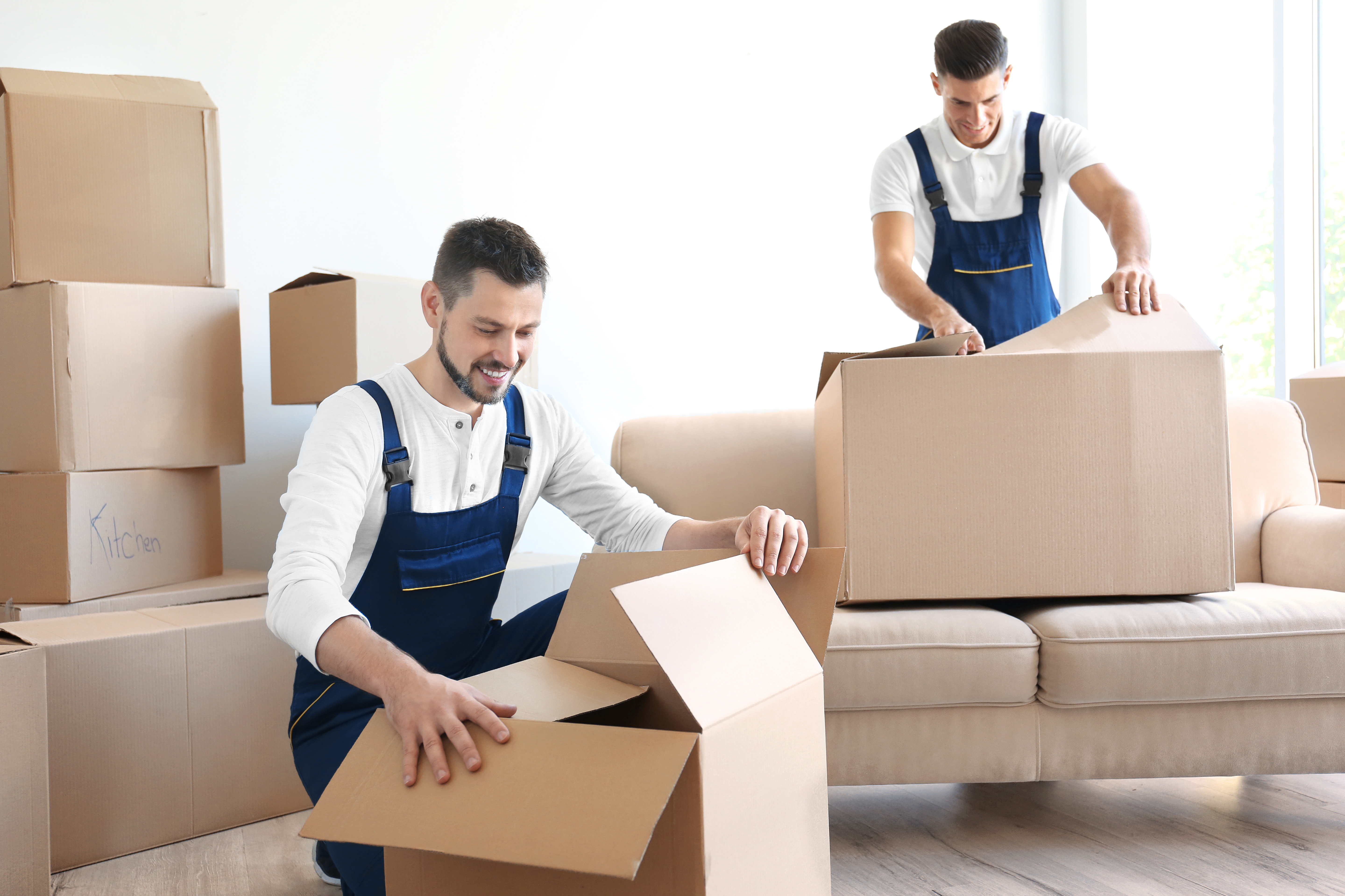 delivery-men-with-moving-boxes-room-new-home.jpg
