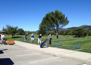 Some folks hitting some practice swings