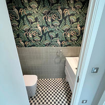 Small bathroom with a jungle-themed wallpaper featuring monkeys and leaves