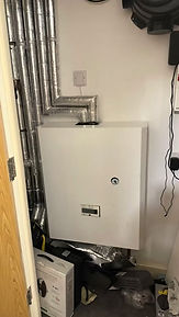A white rectangular boiler unit with a dial and small display