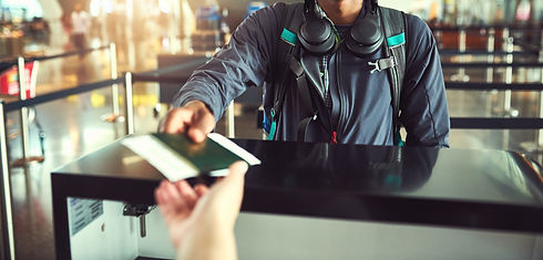 Traveler presenting passport at airport check-in counter before departure