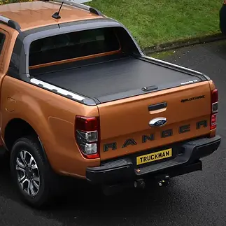 A bronze Ford Ranger pickup truck viewed from the rear, parked on asphalt
