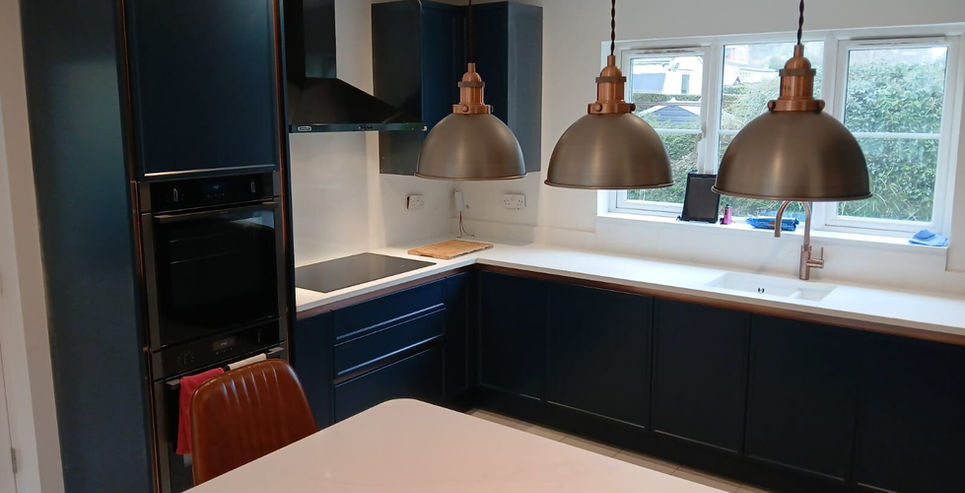 Modern kitchen with navy blue cabinets and leather island barstools