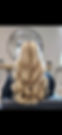 Blonde hair with soft, voluminous waves in a salon setting