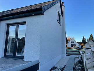 Modern house with a white rough-textured exterior, small window