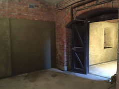 Exposed brick archway and interior room undergoing structural damp proofing renovation