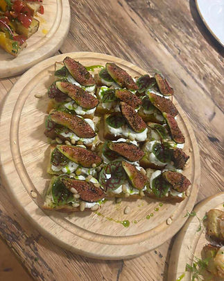 Slices of toasted bread topped with fresh figs, creamy cheese
