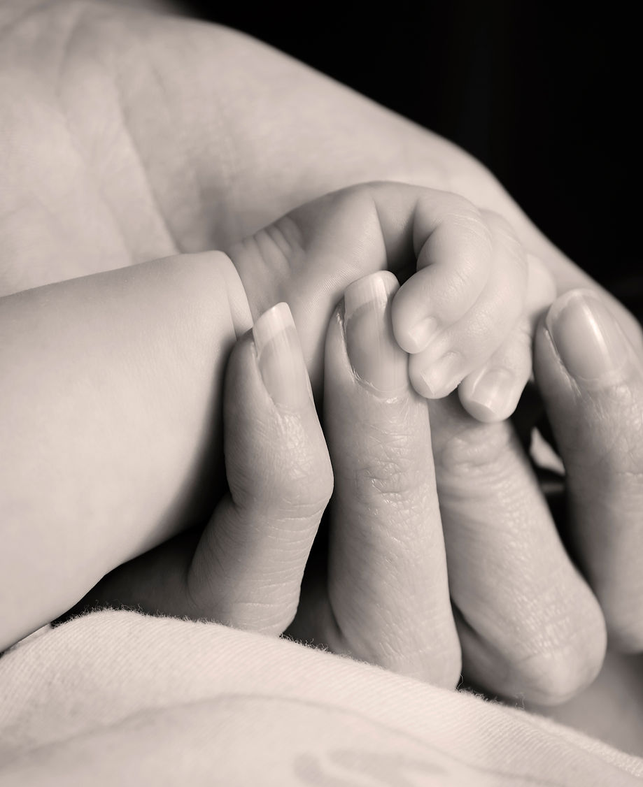 Mother holding baby's hand