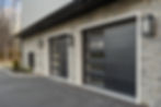 Black garage doors on the exterior of a mansion in North Caldwell, New Jersey.