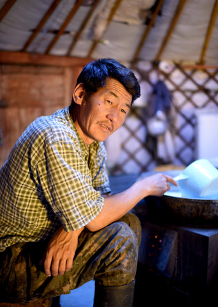Nomad man makes Shimiin arkhi - a type of milk vodka in his ger.
- Mongolia.