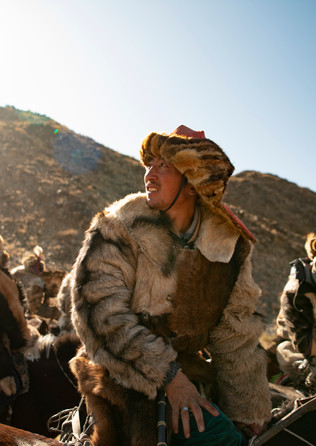 Participants look towards the sky during the Golden Eagle Festival competition.
- Ölgii, Mongolia.