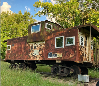 Old rusty train caboose on tracks