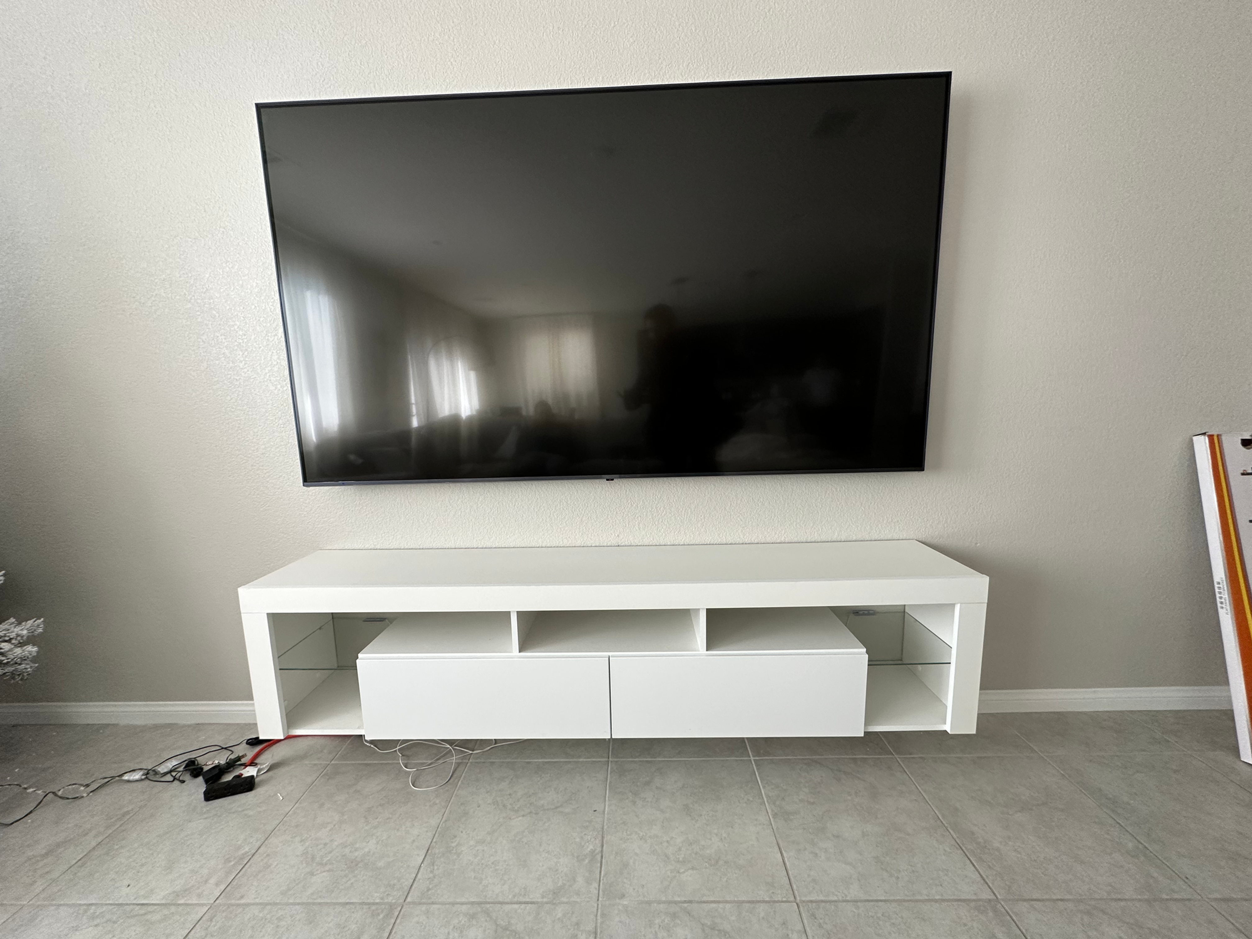 TV mounted above floating tv stand