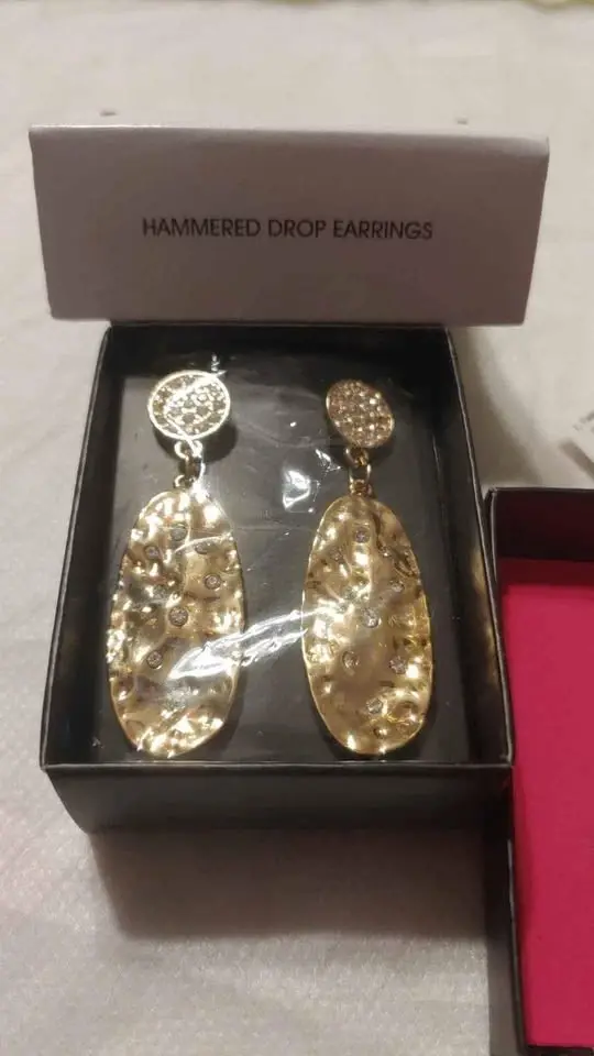 Gold textured dangle earrings in a box