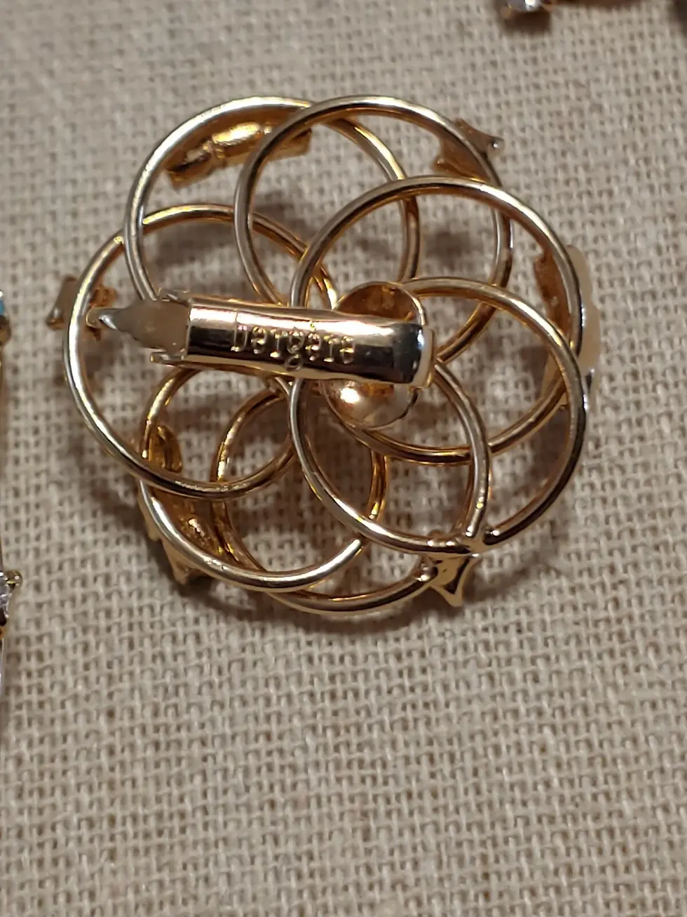 Thumbnail: Gold brooch back with intricate circular design and pin clasp.