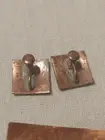 Thumbnail: Two square screw-back fasteners