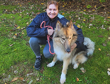 Brigitta Sebesta, owner of Sebesta somatics llc and dog posing outside Sebesta Somatics Llc.