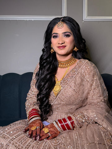 Woman in traditional attire with jewelry and mehndi