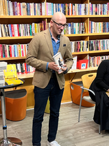 Author holding book at book signing