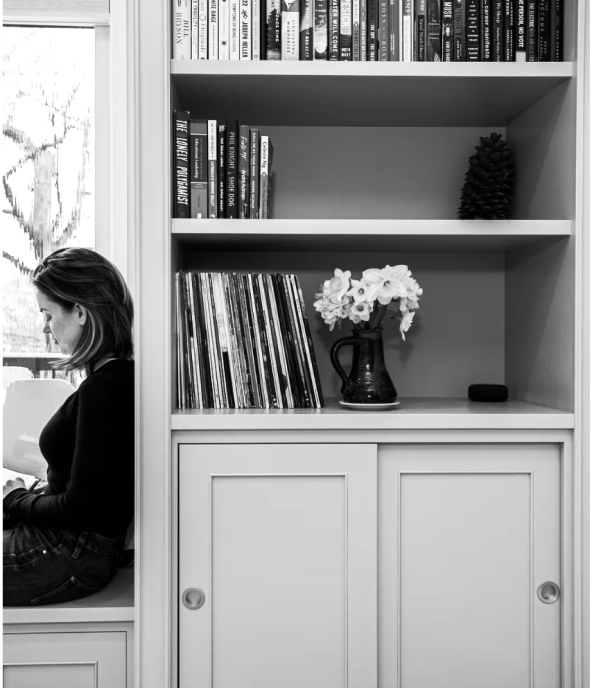 Built-in shelving unit with hidden storage and decorative styling in modern office nook