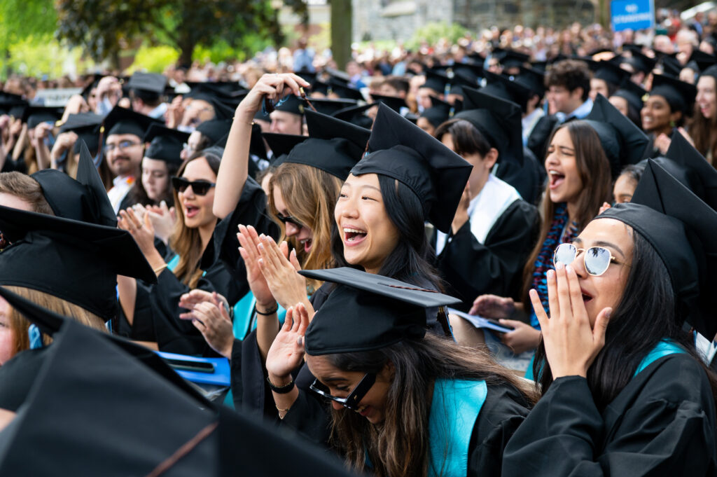 Members of the Class of 2023 cheer during Phase I of Tufts University's 167th Commencement ceremony on Sunday, May 21, 2023. (Alonso Nichols/Tufts University)