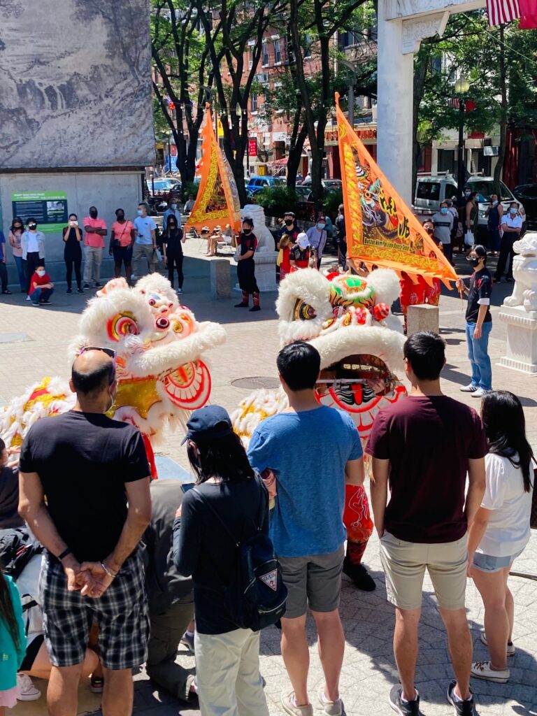 Lion dance with crowd watching
