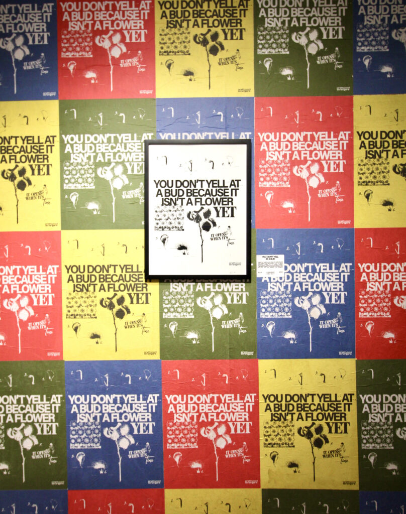 A wall is wheat pasted from floor to ceiling with prettycoolstrangers' work. Photo courtesy by Harmony Witte