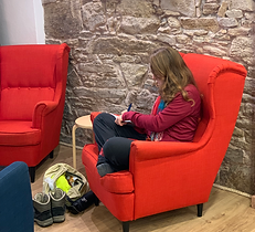 Pilgrim from El Camino De Santiago journaling in our living room. 